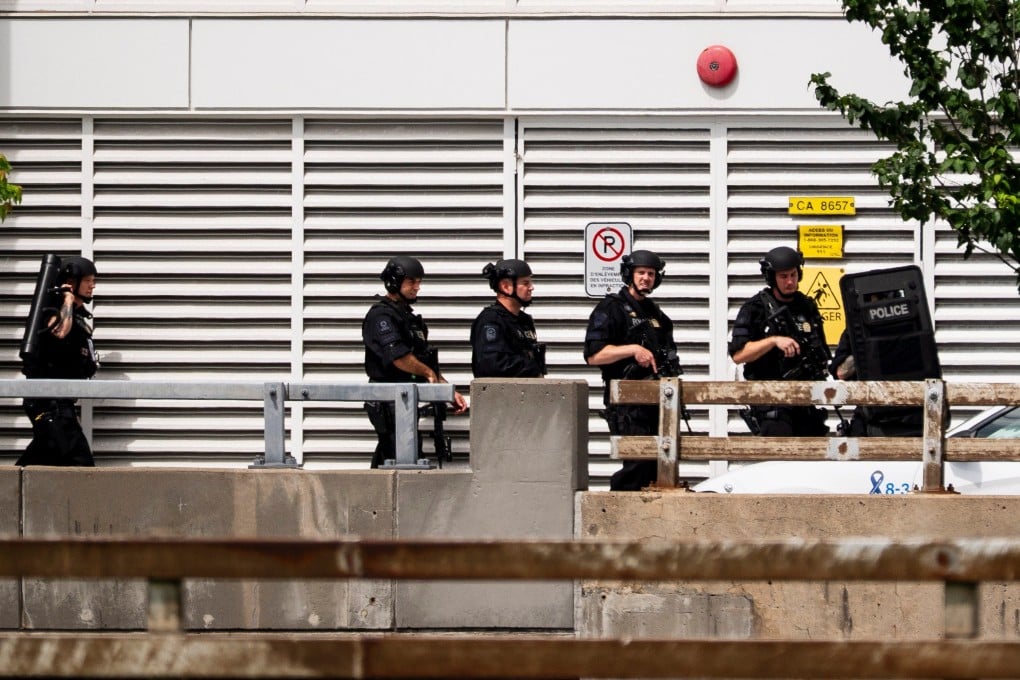 Montreal police prepare to enter building at the scene of the shooting. Photo: The Canadian Press via AP