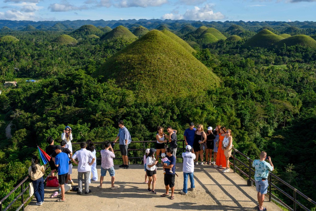 Tourists take photos at Chocolate Hills on Bohol Island in Central Visayas province in the Philippines in December 2025. Photo: AFP