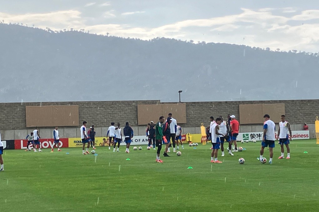 The Colombia players begin a training session as storm clouds gather over the Bosque de la Primavera forest and mountain range in the distance. Photo: Paul McNamara