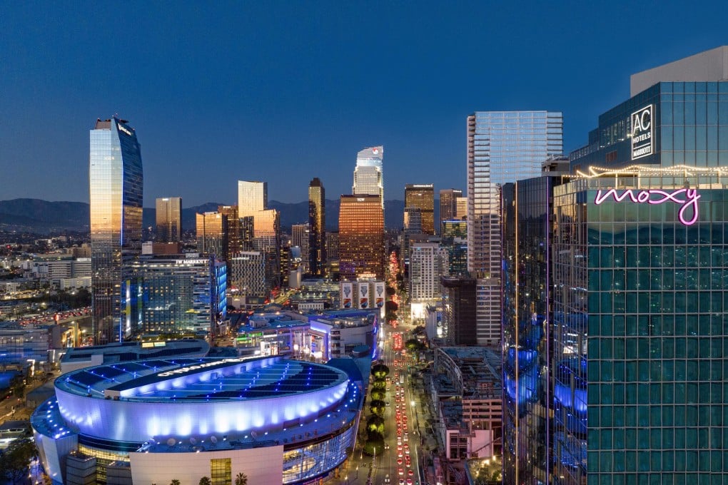 An area of Downtown Los Angeles at sunset with the Crypto.com Arena in the foreground. DTLA has transformed in recent years from a place to be avoided to a walkable entertainment hub perfect for sports fans. Photo: Moxy + AC Hotels DTLA