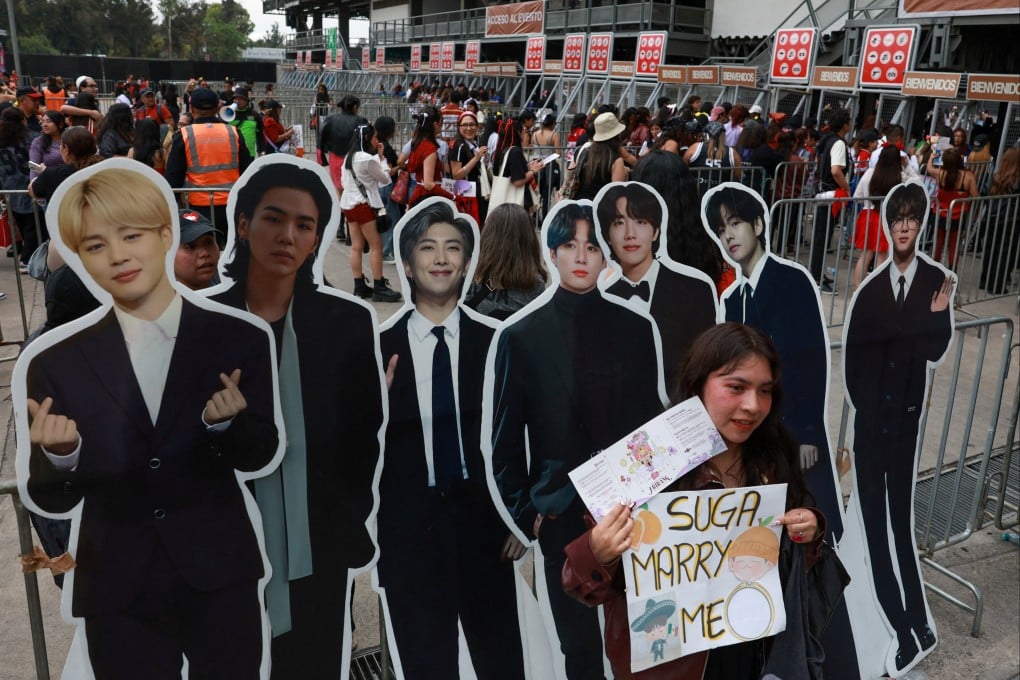 A fan poses with cardboard cut-outs of BTS members before the band’s concert in Mexico last month. Photo: Reuters