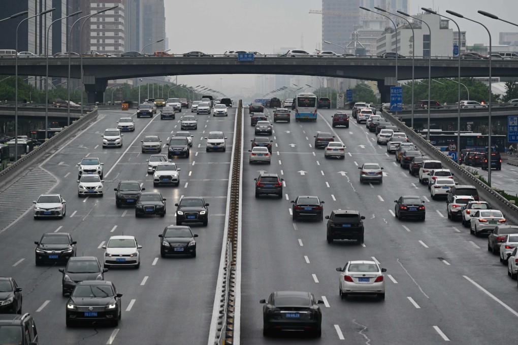 Cars drive along a highway in Beijing. Photo: AFP