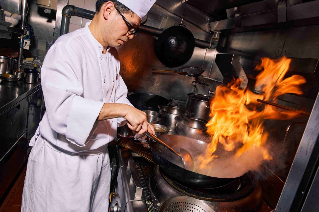 A chef at The Lounge at Four Seasons Hong Kong cooks an item from executive chef Maxime Luvara’s Hong Kong Sizzle menu, which pays homage to Cantonese dai pai dong-style cuisine. Photo: The Lounge @ Four Seasons