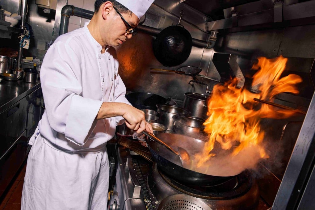 A chef at The Lounge at Four Seasons Hong Kong cooks an item from executive chef Maxime Luvara’s Hong Kong Sizzle menu, which pays homage to Cantonese dai pai dong-style cuisine. Photo: The Lounge @ Four Seasons