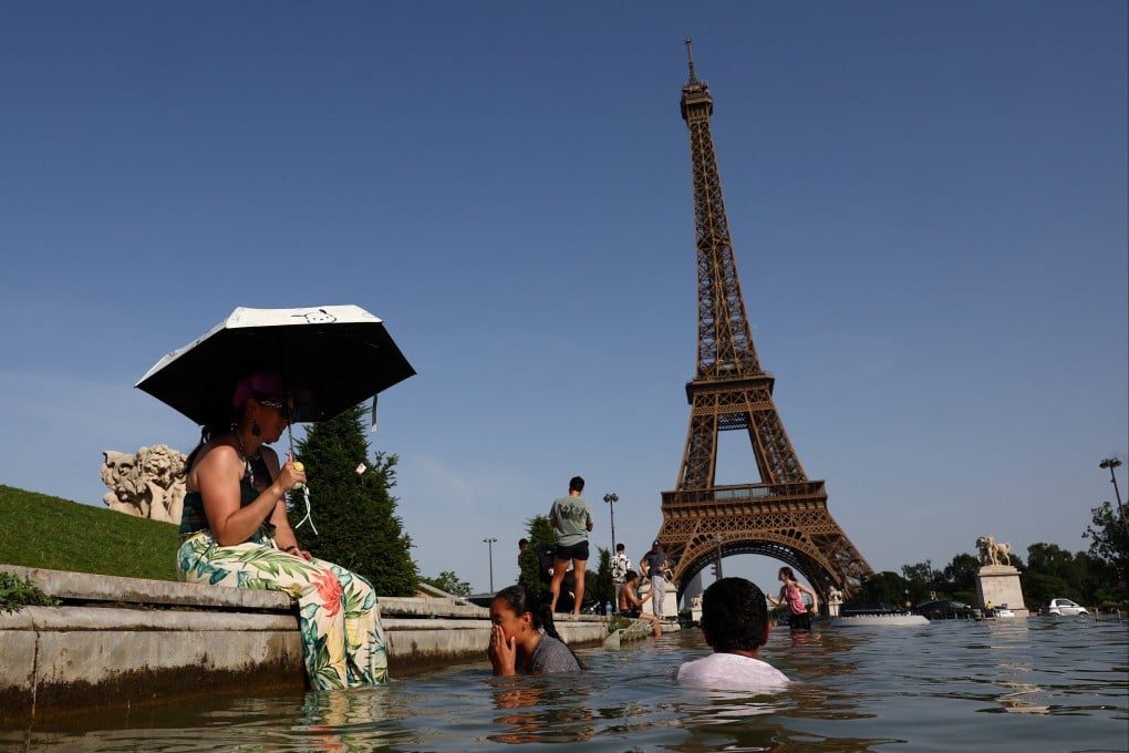 People cool off in the Trocadero fountain in front of the Eiffel Tower on Tuesday as a punishing early-summer heatwave sends temperatures soaring across France. Photo: Reuters