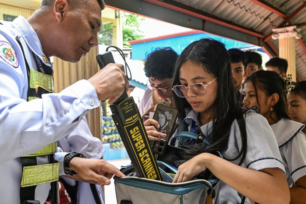 A security guard uses a metal detector to check students’ bags at a high school in Quezon City, the Philippines, on Tuesday, a day after the school shooting in Tacloban. Photo: Reuters