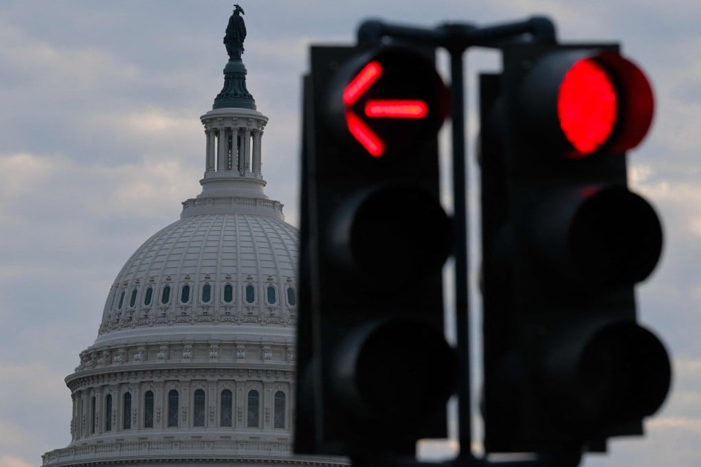 A red traffic signal near the dome of the US Capitol in Washington. In a joint rebuke, both chambers of Congress have voted to halt executive military operations under the War Powers Act. Photo: AFP