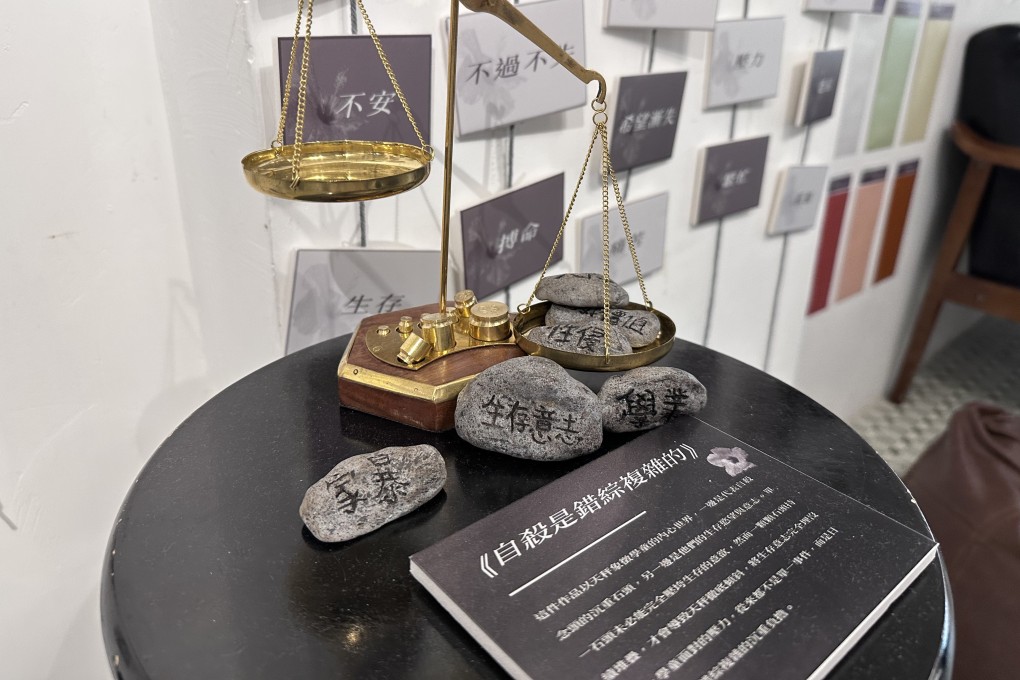 An exhibition by the Hong Kong Student Alliance on Student Suicide uses a scale to demonstrate the reasons why student take their lives. Photo: William Yiu