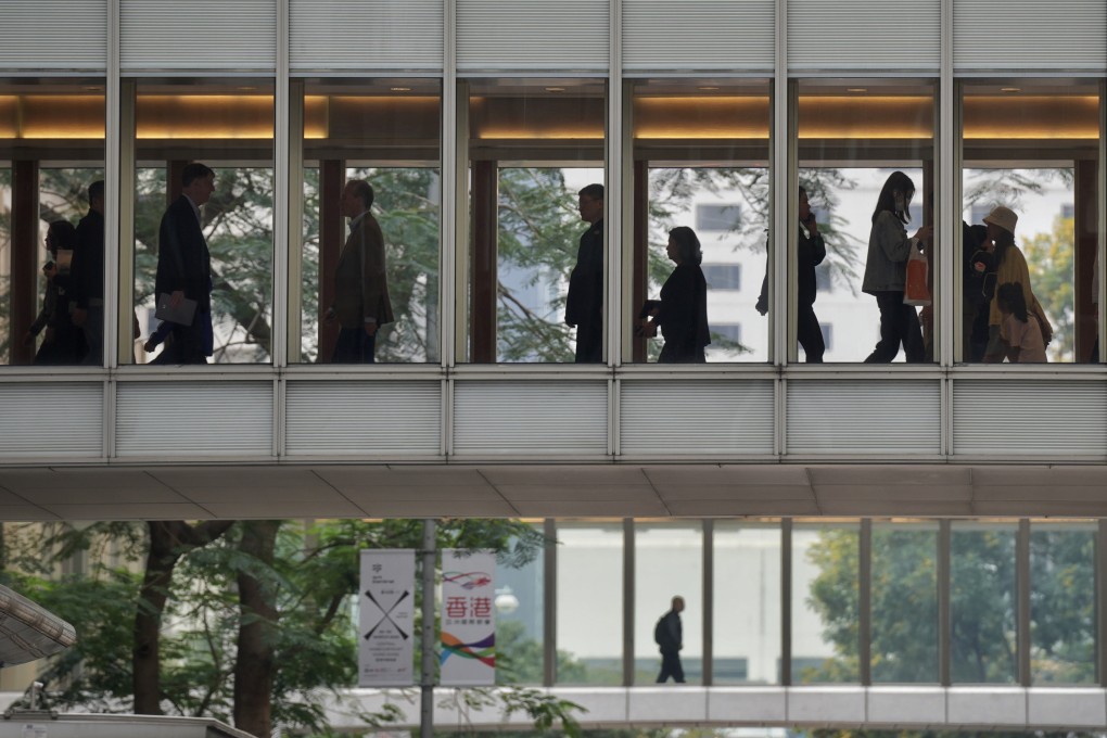 Pedestrians walk on a footbridge in Central. Photo: Elson Li