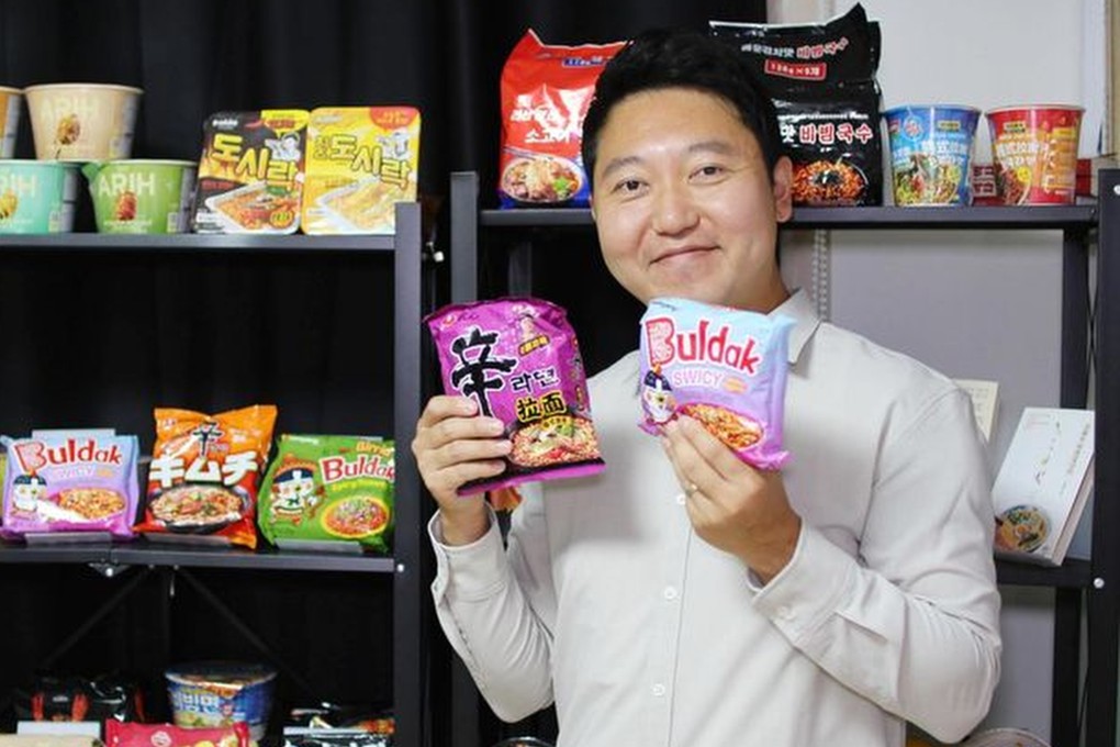 Instant noodle critic and expert Ji Young-jun holds packets of Shin Ramyun and Buldak Swicy Spicy Ramen, two of the most-loved Korean instant noodles. Photo: courtesy of Ji Young-jun