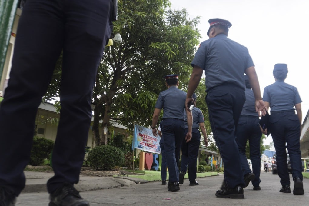 Philippine police officers enter the San Jose National High School in Tacloban City, Leyte province, Philippines, on Monday. Photo: EPA