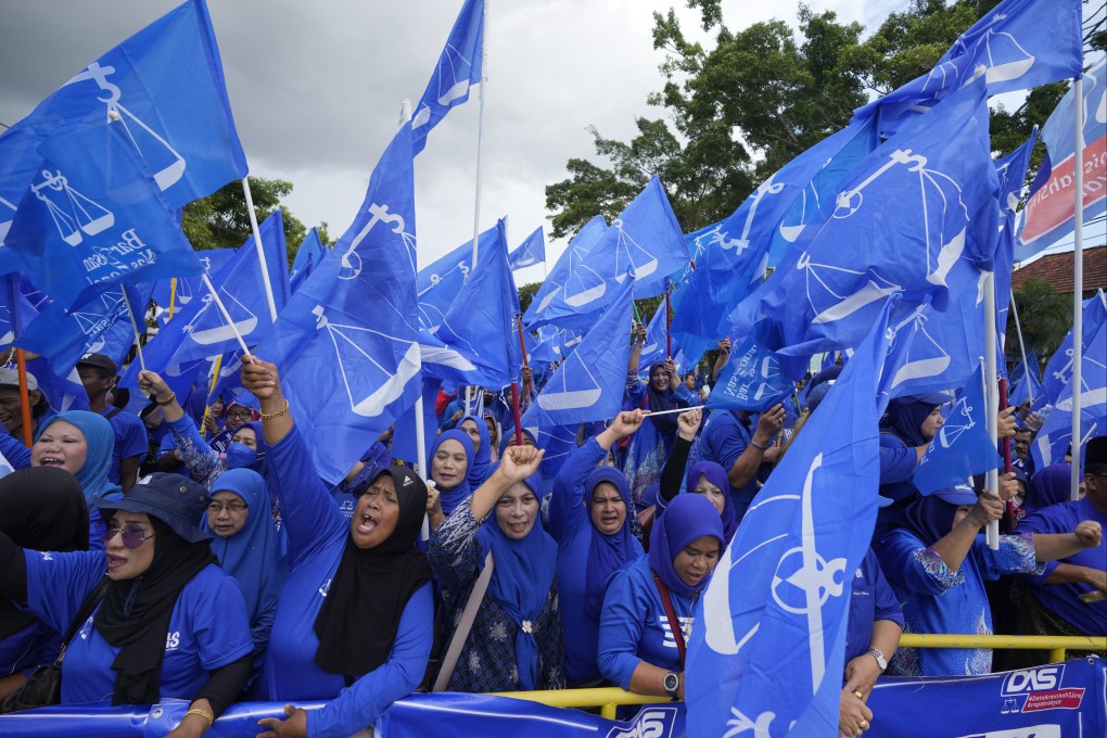 Supporters of Malaysia’s Barisan National coalition led by the United Malays National Organisation, wave flags in 2022. Photo: AP