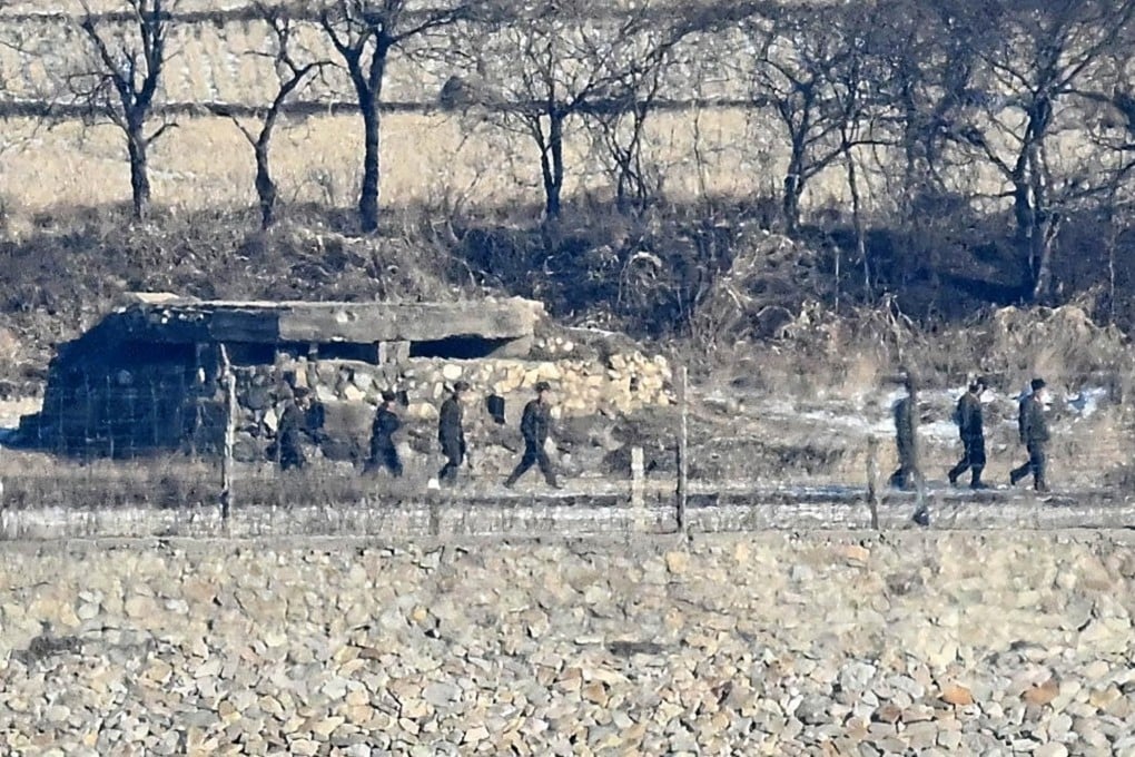 North Korean soldiers move along a fence line near Yujeong-dong village in North Korea, as seen from the Ganghwa Peace Observatory in Incheon in 2024. Photo: The Korea Times
