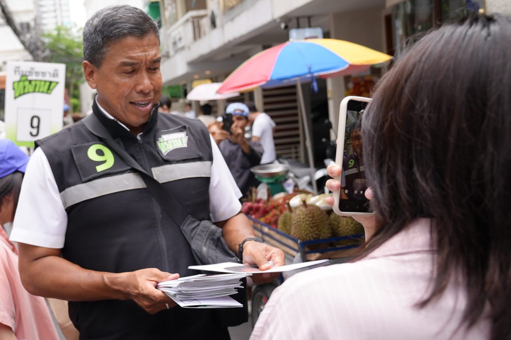 Bangkok governor Chadchart Sittipunt hands out leaflets while campaigning trail in the Thai capital. Photo: Aidan Jones
