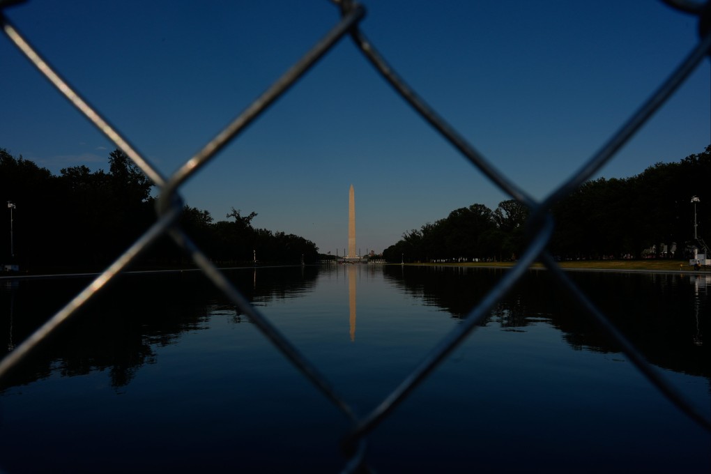 The Washington Monument, reflected in the Lincoln Memorial Reflecting Pool, as seen behind a chain link fence on Thursday Photo: AP