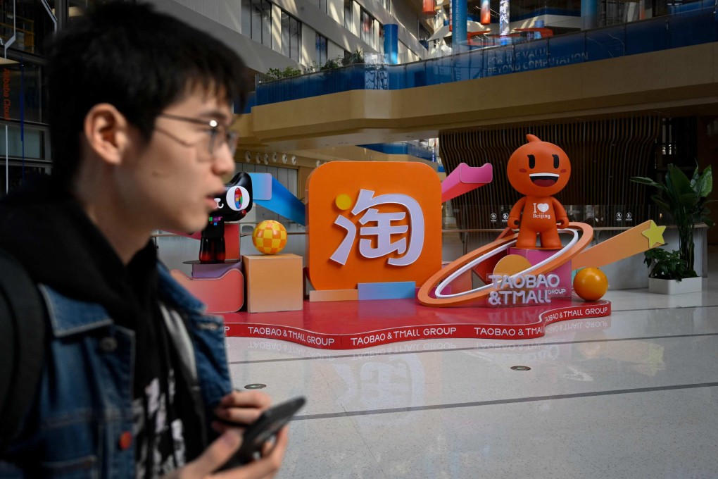A man walks past a Taobao and Tmall display at the Alibaba office in Beijing. Photo: AFP