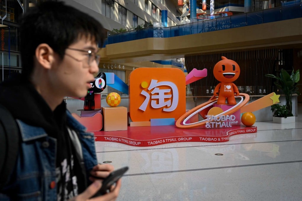 A man walks past a Taobao and Tmall display at the Alibaba office in Beijing. Photo: AFP