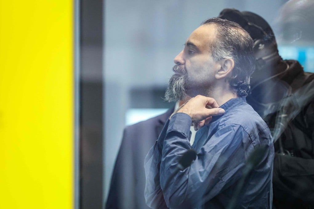 Saudi Arabian defendant, psychiatrist Taleb Jawad al-Abdulmohsen, waits inside a bulletproof glass box in a courtroom in Germany before his trial for driving an SUV through a crowd at a Christmas market. Photo: AFP