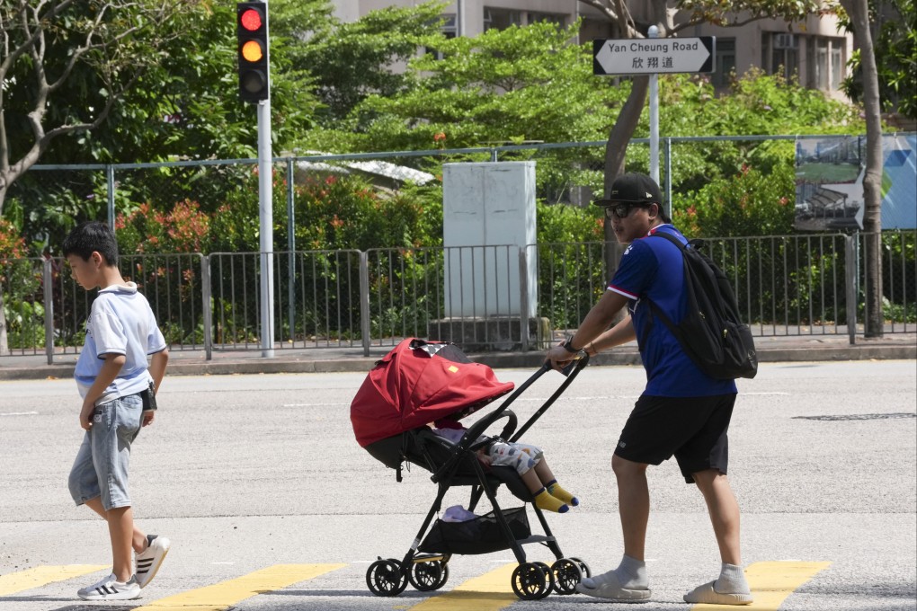 A man pushes a baby in a pram in Yau Ma Tei on July 17, 2025. Photo: Jelly Tse