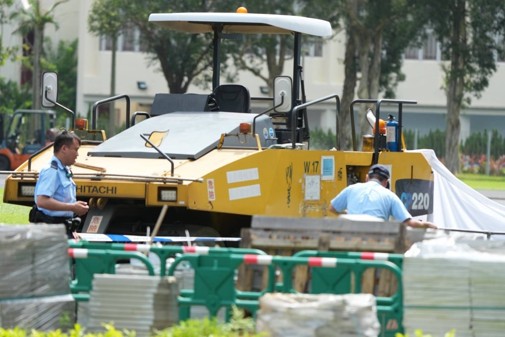 Investigators inspect the scene at Kowloon Bay Sports Ground, where a worker died after being run over by a construction vehicle on June 26. Photo: Dickson Lee