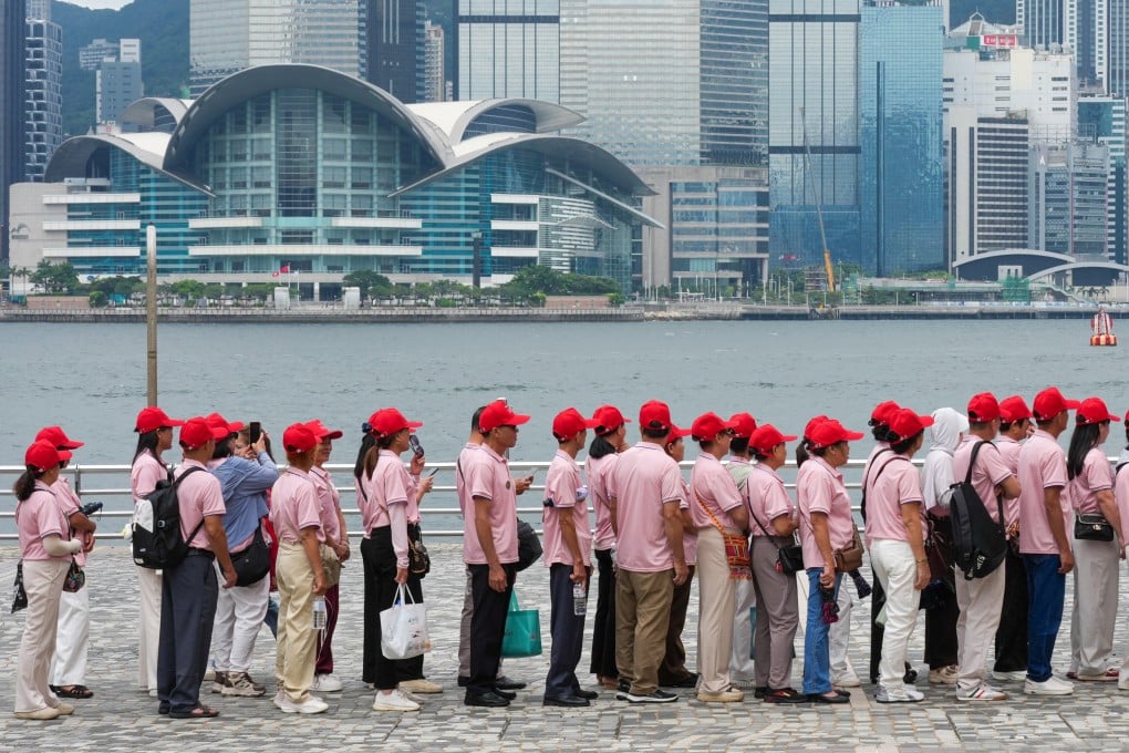 A group of mainland tourists gather along the Tsim Sha Tsui promenade on June 9. Photo: Jelly Tse