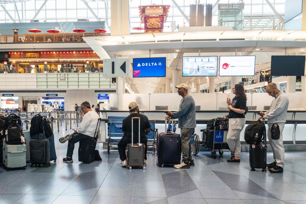 Passengers wait at Haneda airport in Tokyo on June 3. Photo: AFP