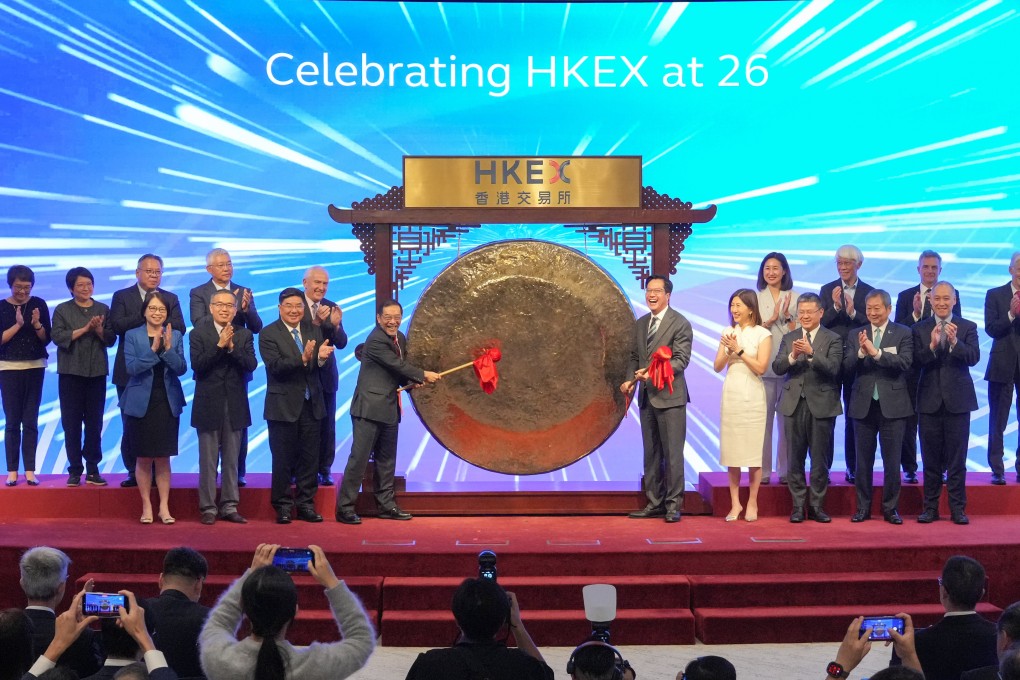 HKEX chairman Carlson Tong and Deputy Financial Secretary Michael Wong strike the gong to mark the bourse operator’s 26th anniversary. Photo: May Tse