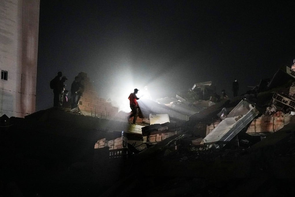 Residents and rescue workers search through the rubble two days after an earthquake struck in La Guaira, Venezuela, on Friday. Photo: AP