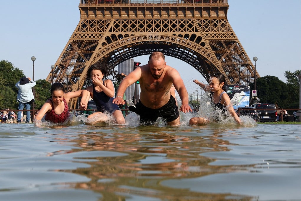 People cool off in the Trocadero Fountain next to the Eiffel Tower as temperatures rise during a heatwave affecting a large part of the country, in Paris, France, on Monday. Photo: Reuters
