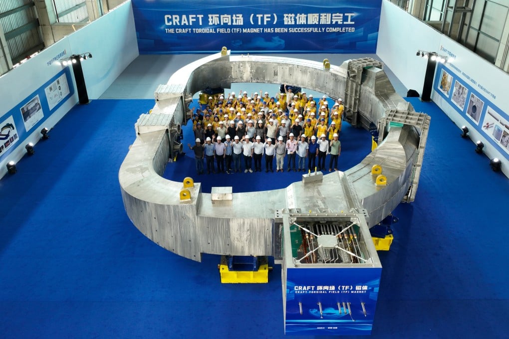 The team behind the superconducting magnet project celebrate the success of their tests on Saturday, capping years of work. Photo: Xinhua