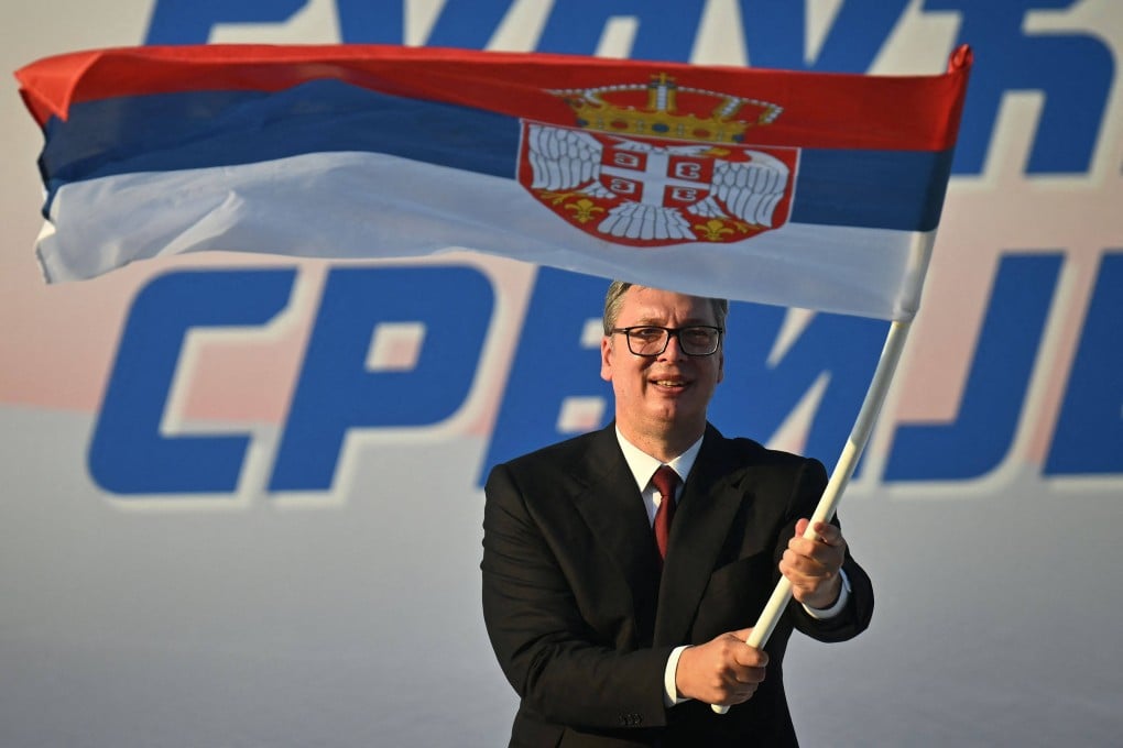 President Aleksandar Vucic waves a Serbian flag during a rally in Belgrade on Saturday. Photo: AFP