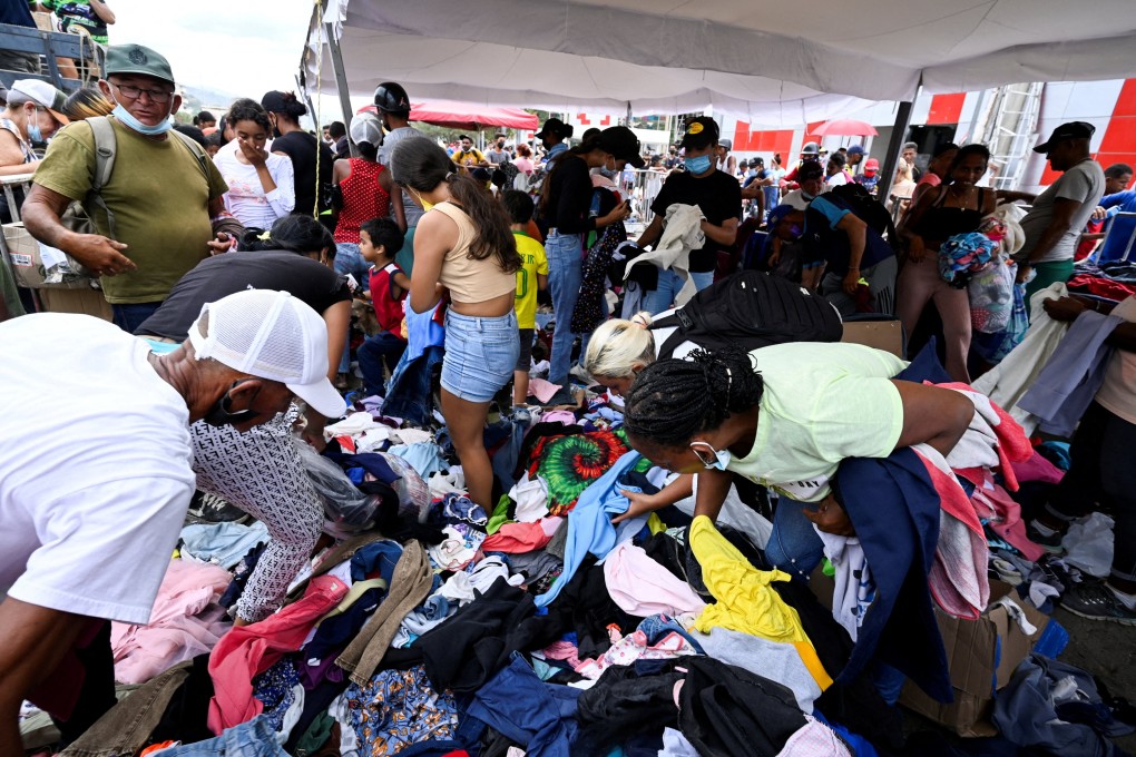 People sift through donated clothes on a street in La Guaira, Venezuela, on Sunday, following two devastating earthquakes that struck the region. Photo: Reuters