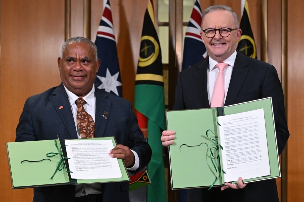 Vanuatu’s Prime Minister Jotham Napat (left) and Australian Prime Minister Anthony Albanese present the signed Nakamal agreement at Parliament House in Canberra on Monday. Photo: EPA