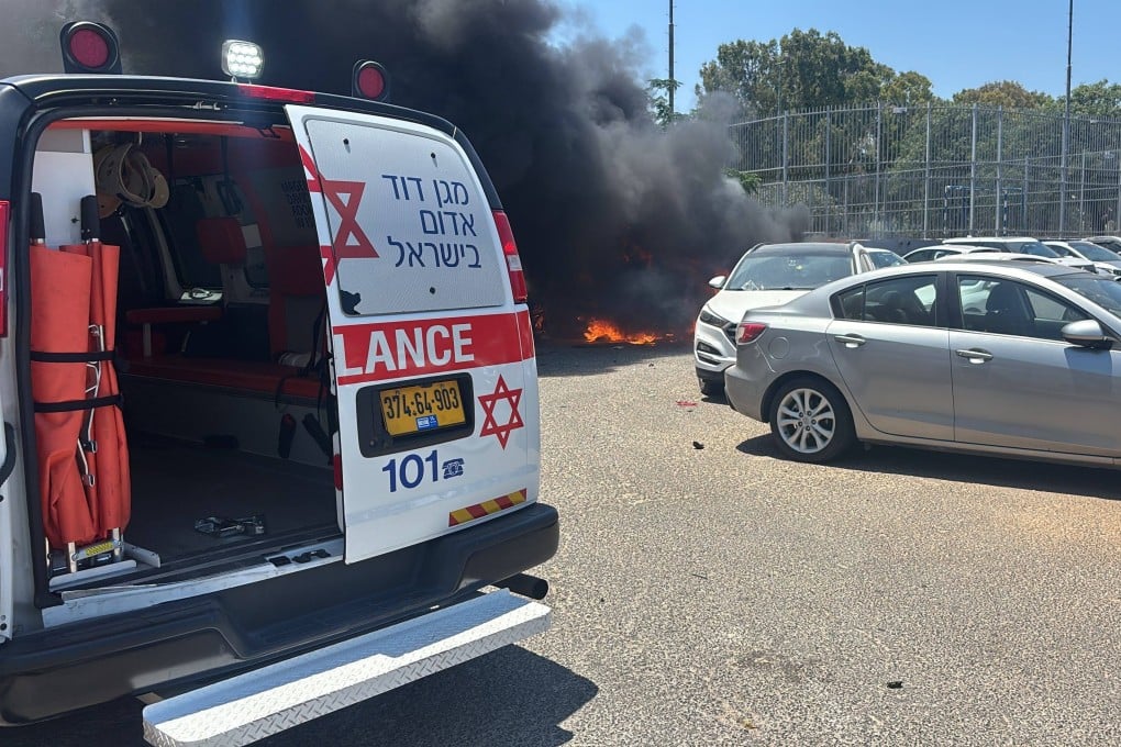 An Israeli ambulance car is parked near a car that exploded after being hit by a bomb in Holon, a suburb of Tel Aviv, Israel on Sunday. Photo: Rettungsdienst Magen David Adom / dpa