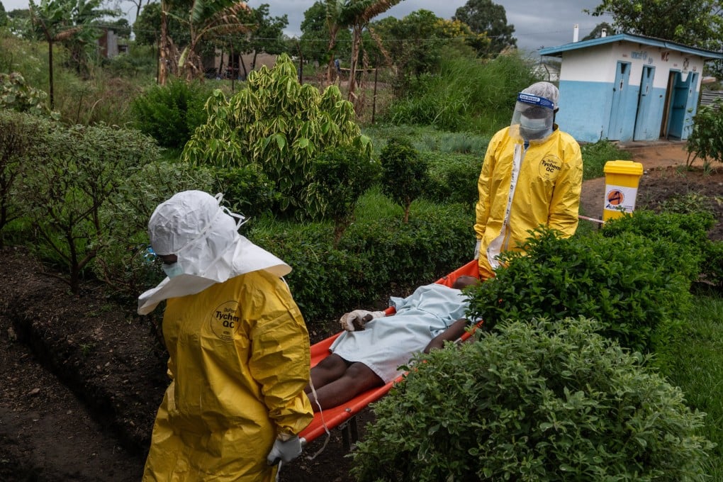 Medical staff carry an Ebola patient to a treatment centre in Rwampara in the Democratic Republic of Congo in late May. Photo: AP