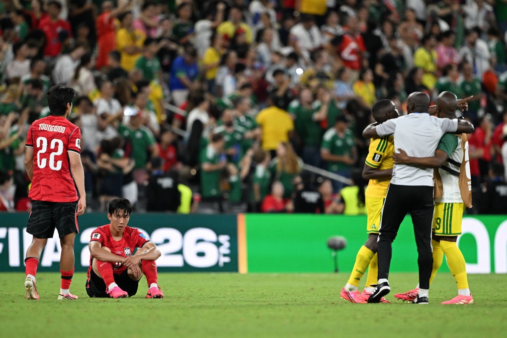 South Korean players look on as the South Africa team celebrate their 1-0 win, and qualification to the second round, last week. Photo: Xinhua