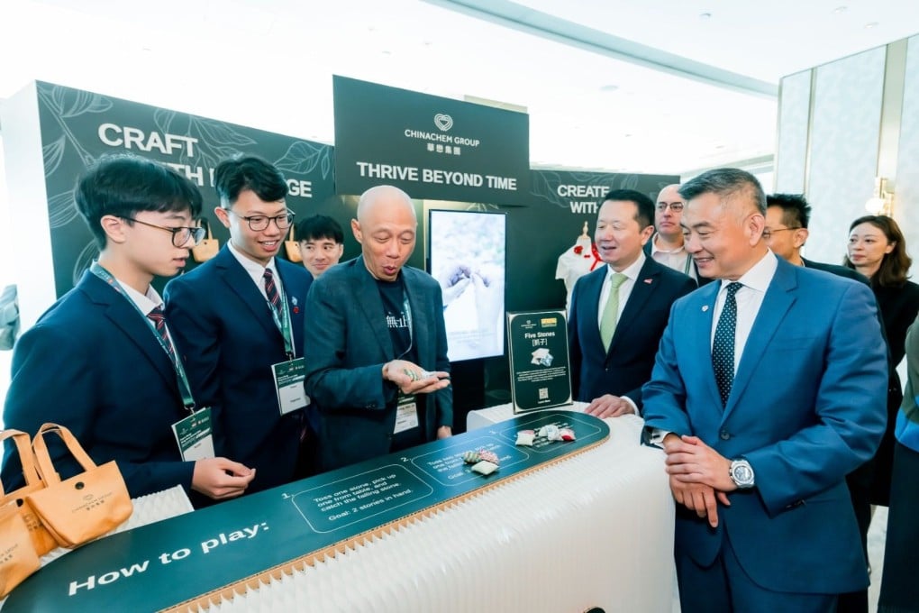 Conference attendees, including Andy Cheung, executive director and CEO of Chinachem Group (right) take a break from the proceedings to enjoy a traditional game of ‘five stones’.