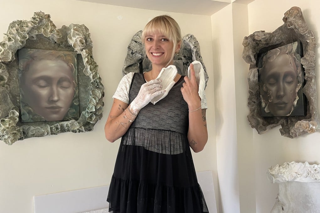Czech artist and “coral gardener” Marketa Kolarova is pictured at her Ma Wan 1868 residency holding plaster moulds of her hands that will be added to works that will be unveiled at an exhibition on site on July 12, 2026. Photo: Enid Tsui