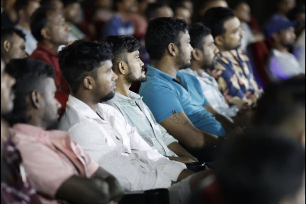 Migrant workers listen to Singapore officials speak about the measures to help those who have not been paid wages for months. Photo: Facebook/Ng Chee Meng
