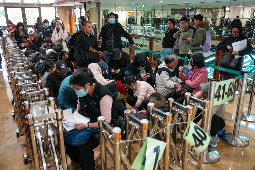 People queue overnight for test-free driving licence applications outside the Transport Department licensing office. Photo: Sam Tsang