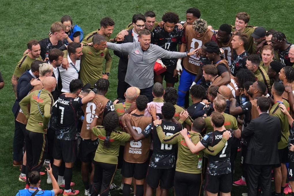 Canada head coach Jesse Marsch (centre), celebrates with his players after beating South Africa. Photo: AP