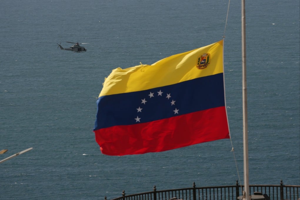 A helicopter takes off from a US Navy ship docked at the seaport to support earthquake relief efforts in La Guaira, Venezuela on Monday. Photo: AP