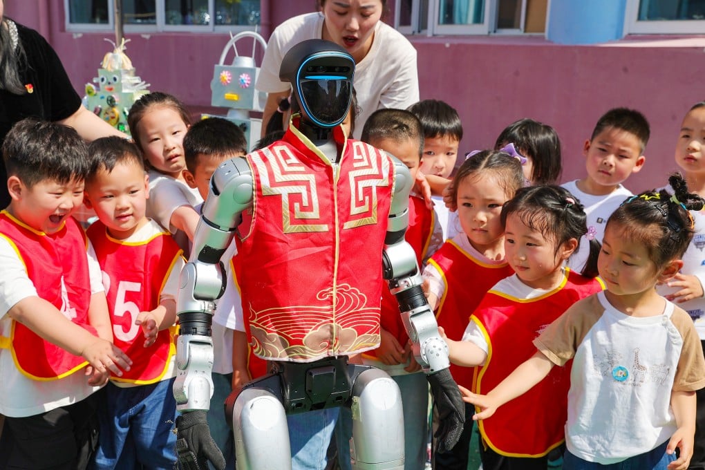 Children play with a humanoid robot on May 28 in Huaibei, Anhui province. Kindergartens and primary schools are closing while university dormitories remain packed amid falling birth rates – a mismatch that captures the challenge facing China’s education planners. Photo: Getty