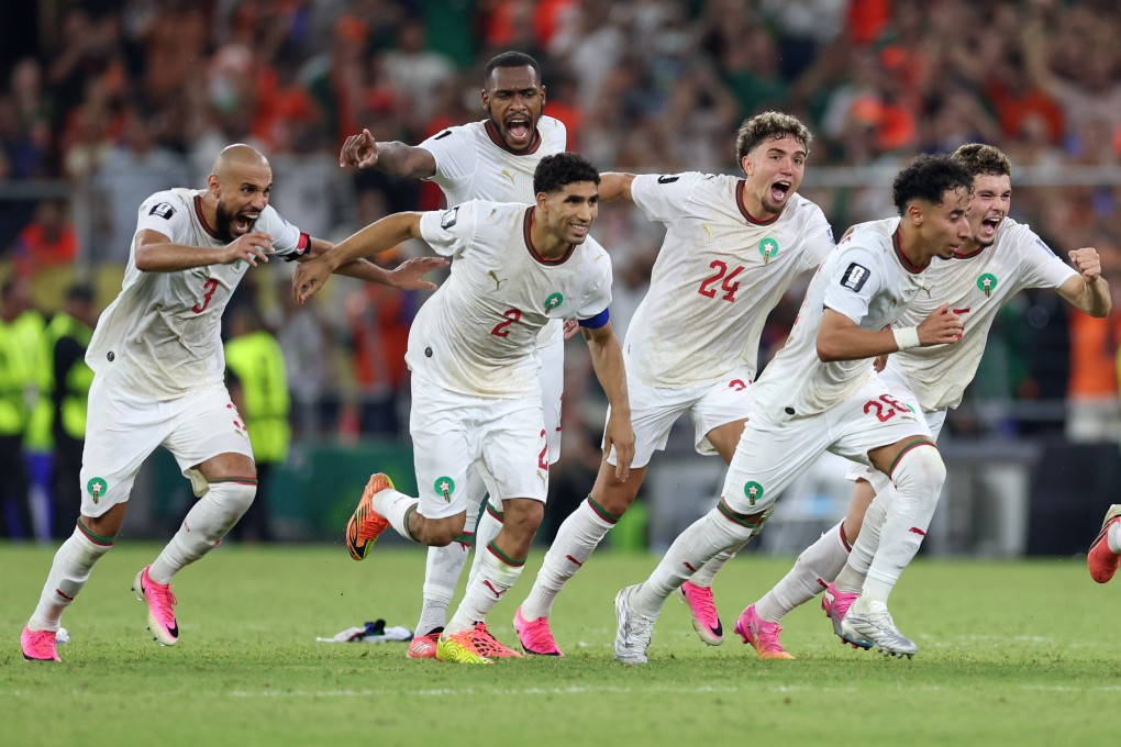 Morocco’s jubilant players begin their celebrations after Ismael Saibari’s winning penalty. Photo: AP Photo
