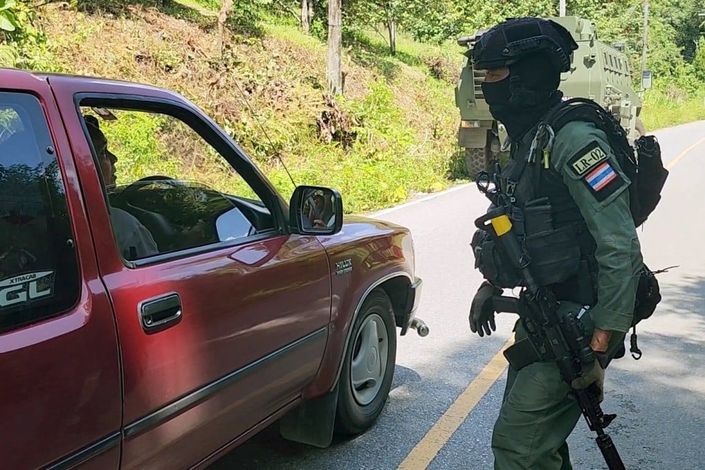 A Thai border patrol policeman inspects a villager’s vehicle on June 19. Photo: EPA