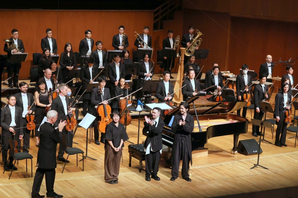 Time (in-)Linear composer Alice Yeung (second from left) on stage with conductor Christoph Poppen (left), jazz pianist Daniel Chu (second from right) and CY Leo (right) after the world premiere of Yeung’s concerto for chromatic harmonica, jazz piano and orchestra, on June 27, 2026. Photo: Hong Kong Sinfonietta