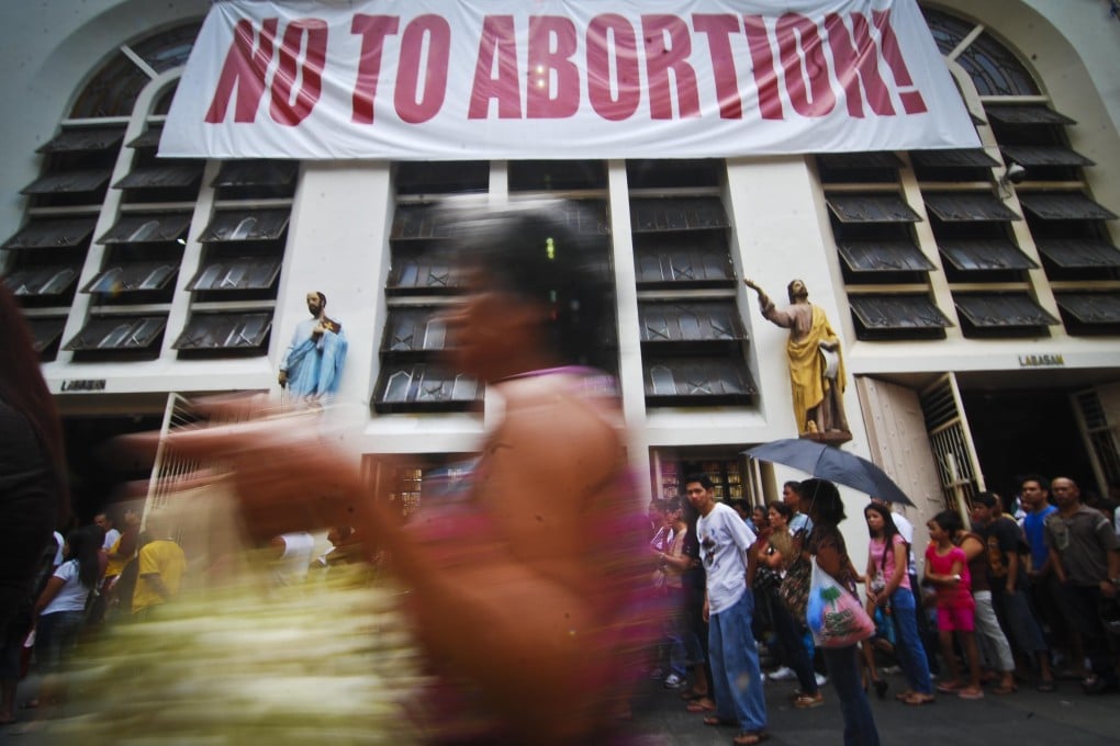 A placard is displayed in front of the Minor Basilica of the Black Nazarene in Quiapo, the Philippines, during a Catholic organised anti-abortion rally in 2011. Photo: Getty Images