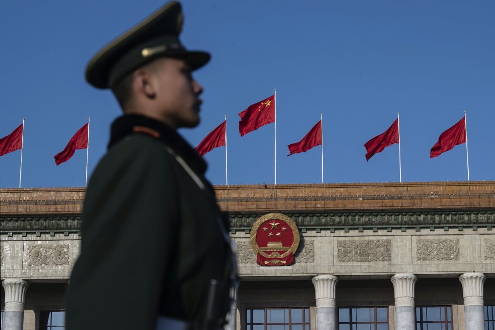 A guard stands at attention outside the Great Hall of the People in Beijing. China has enacted a sweeping overseas investment law. Photo: TNS