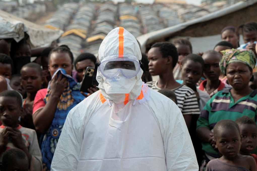 A health worker and displaced people wait for the burial of suspected Ebola victims in Bunia in the eastern Democratic Republic of Congo. Photo: Reuters