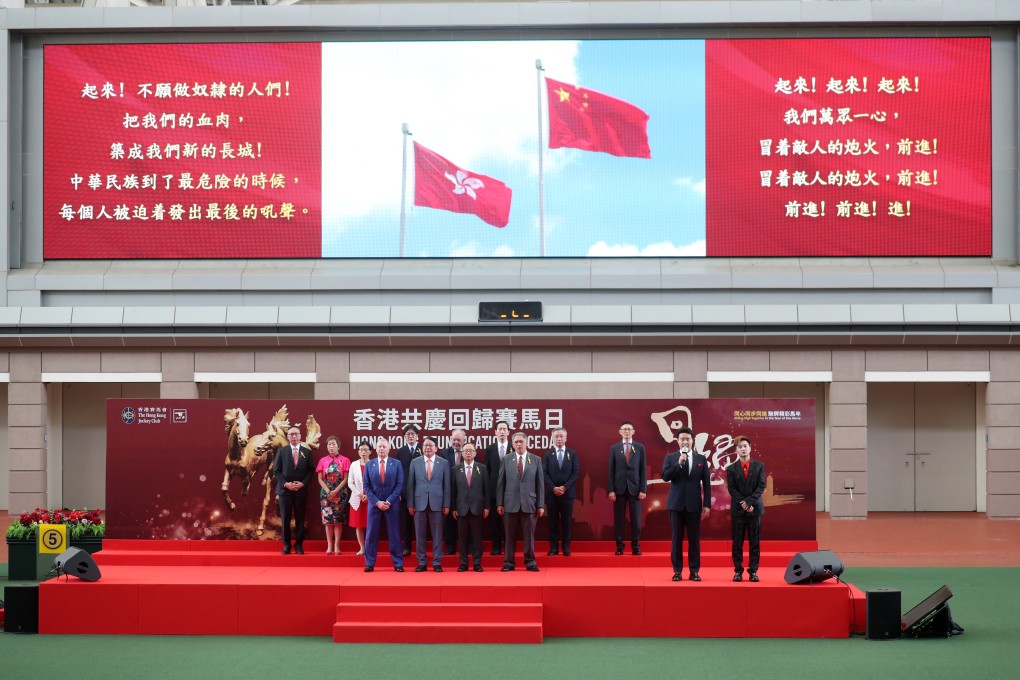 Zhang Yingxi (second from right) leads the singing of the national anthem during the opening ceremony of the Hong Kong Reunification Raceday at Sha Tin Racecourse. Photo: Kenneth Chan.